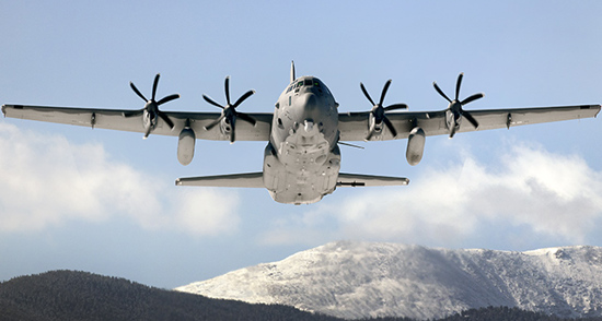 Modified C-130 in Flight over mountains